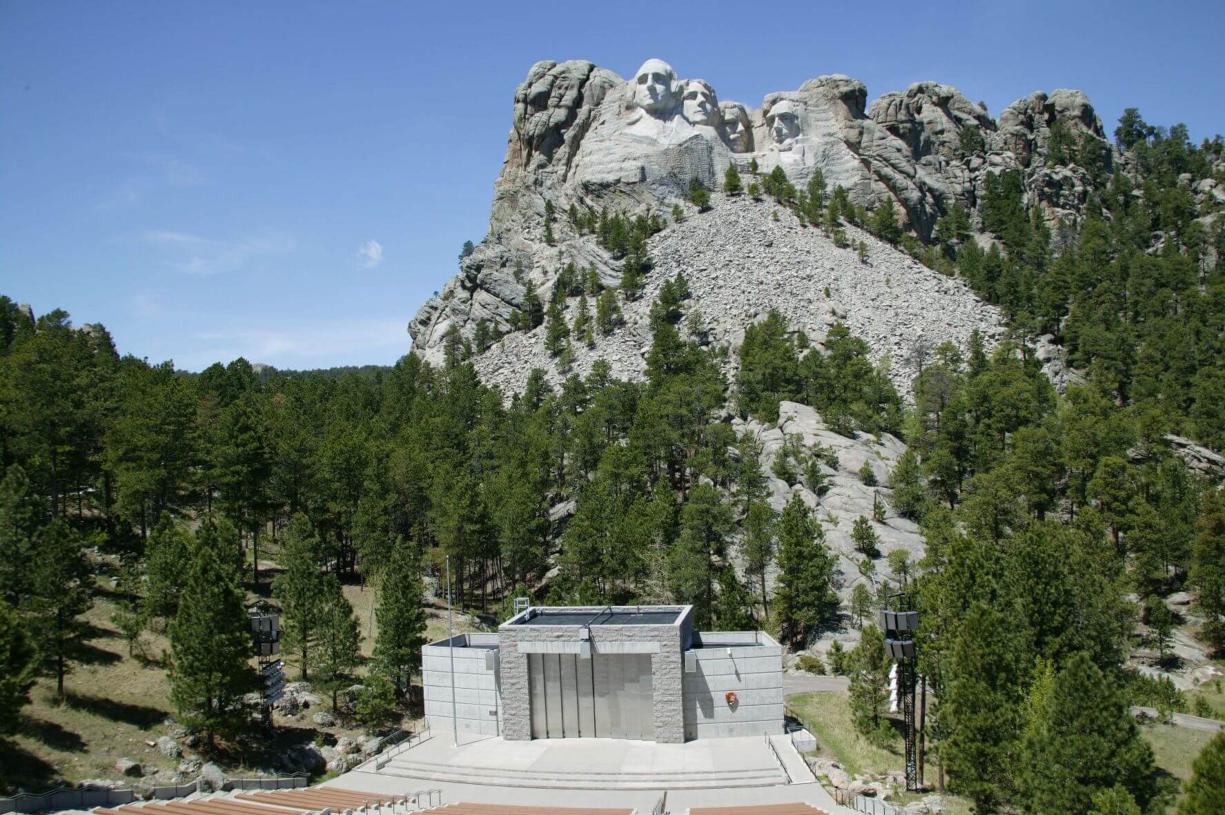 mount rushmore with a concrete state infront